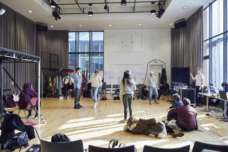 Wide shot of actors in a rehearsal room